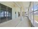Spacious lanai with ceiling fan and multiple entry points overlooking the lake at 5596 Sabal Trace Dr, North Port, FL 34287