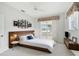 This bright main bedroom features a ceiling fan, sliding glass doors, and neutral carpeting at 5596 Sabal Trace Dr, North Port, FL 34287