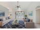 Bright living room featuring a plush rug, comfortable seating, and large windows with views of the lake at 5596 Sabal Trace Dr, North Port, FL 34287