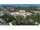 An aerial view shows the house among the trees of a quiet neighborhood near the water at 590 Artists Ave, Englewood, FL 34223