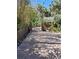 Paver patio and walkway in backyard, enclosed by mature tropical trees and fencing at 590 Artists Ave, Englewood, FL 34223