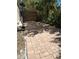 Paver patio backyard area with mature trees and a wooden fence for privacy at 590 Artists Ave, Englewood, FL 34223