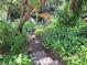 Path leading to water with mature landscaping at 590 Artists Ave, Englewood, FL 34223