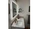 Vanity area features a backlit mirror with designer fixtures and modern decor at 590 Artists Ave, Englewood, FL 34223