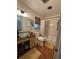 Bathroom with a glass vessel sink, modern fixtures, and decorative window with neutral tones at 590 Artists Ave, Englewood, FL 34223
