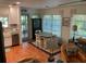Charming dining area with views of the outdoors, next to the kitchen with lots of natural light at 590 Artists Ave, Englewood, FL 34223