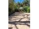 Long paved driveway and wooden gate surrounded by bamboo and lush landscaping at 590 Artists Ave, Englewood, FL 34223