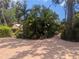 Beautiful home with mature trees and landscaping, creating a private and serene setting at 590 Artists Ave, Englewood, FL 34223