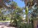 Mature tropical landscaping on a sunny day at 590 Artists Ave, Englewood, FL 34223