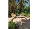 Outdoor brick patio with garden seating and tropical plants at 590 Artists Ave, Englewood, FL 34223