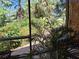View from screened patio with lush tropical landscaping and brick patio at 590 Artists Ave, Englewood, FL 34223
