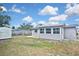 Spacious backyard showing sunroom, shed, and partial fence at 5905 Olive Ave, Sarasota, FL 34231