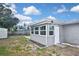 Backyard featuring the sunroom, shed, and white trim at 5905 Olive Ave, Sarasota, FL 34231
