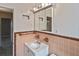 Functional bathroom featuring classic fixtures, mirror, and a tiled surround at 5905 Olive Ave, Sarasota, FL 34231