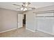 Bedroom featuring a ceiling fan, a closet, and neutral-colored carpet at 5905 Olive Ave, Sarasota, FL 34231