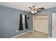 Bedroom featuring a closet, a ceiling fan, and two windows with black curtains at 5905 Olive Ave, Sarasota, FL 34231