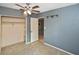 Cozy bedroom with closet and door to another room, complemented by a ceiling fan at 5905 Olive Ave, Sarasota, FL 34231