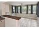 Bonus room featuring a breakfast bar, tile floors, and access to the kitchen and outside at 5905 Olive Ave, Sarasota, FL 34231