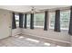 Bonus room featuring a ceiling fan, tile floors, natural lighting, and outside access at 5905 Olive Ave, Sarasota, FL 34231