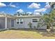 Home featuring a well-maintained lawn, and freshly painted exterior with new energy efficient windows at 5905 Olive Ave, Sarasota, FL 34231