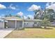 Charming single-story home featuring a carport, a well-maintained lawn, and freshly painted exterior at 5905 Olive Ave, Sarasota, FL 34231