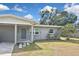 Charming single-story home featuring a carport, a well-maintained lawn, and freshly painted exterior at 5905 Olive Ave, Sarasota, FL 34231