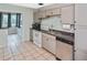 This functional kitchen offers tile floors, light cabinets and appliances at 5905 Olive Ave, Sarasota, FL 34231