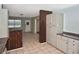 Kitchen with tile flooring and cabinets with views of front door and entry to a living room at 5905 Olive Ave, Sarasota, FL 34231