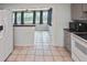 Spacious kitchen with tile floors, appliances, and access to a naturally lit bonus room at 5905 Olive Ave, Sarasota, FL 34231