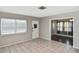 Living room with tile flooring, a front door, and an open view to the room with dark brown floors at 5905 Olive Ave, Sarasota, FL 34231