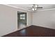 View of a living room featuring hardwood-style flooring, ceiling fan, and open access to another room at 5905 Olive Ave, Sarasota, FL 34231
