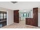 Spacious living area with tile flooring flows into kitchen and adjacent room through doorway at 5905 Olive Ave, Sarasota, FL 34231