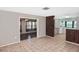 Spacious living room with tile flooring, a ceiling fan, and an open floor plan at 5905 Olive Ave, Sarasota, FL 34231