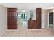 Open concept living area with tile flooring offering views into kitchen and front hallway at 5905 Olive Ave, Sarasota, FL 34231