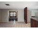 Open living space with tiled floors showcases access to bedroom with hardwood floors at 5905 Olive Ave, Sarasota, FL 34231