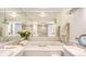 Luxurious bathroom with soaking tub, tiled walls, and mirrored accents at 5966 Midnight Pass Rd # G-51 & G-58, Sarasota, FL 34242