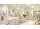 Well-lit bathroom with double vanity, soaking tub, and elegant fixtures at 5966 Midnight Pass Rd # G-51 & G-58, Sarasota, FL 34242