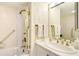 Well-maintained bathroom with a shower-tub combo, white vanity, and brass fixtures at 5966 Midnight Pass Rd # G-51 & G-58, Sarasota, FL 34242