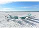 Relaxing beach scene with lounge chairs scattered across the white sand, perfect for enjoying the sun and ocean views at 5966 Midnight Pass Rd # G-51 & G-58, Sarasota, FL 34242