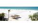 Picturesque beach with palm trees, covered picnic areas, and clear blue water, ideal for a relaxing day at 5966 Midnight Pass Rd # G-51 & G-58, Sarasota, FL 34242