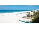 Beautiful beach with turquoise water, blue umbrellas, palm trees, and white sand, perfect for relaxation at 5966 Midnight Pass Rd # G-51 & G-58, Sarasota, FL 34242