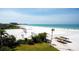 Scenic beach with palm trees, cabanas, and crystal-clear water, offering a tranquil and inviting atmosphere at 5966 Midnight Pass Rd # G-51 & G-58, Sarasota, FL 34242