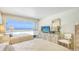 Bright bedroom with two beds, dresser, beach view, and neutral tones, ideal for relaxation at 5966 Midnight Pass Rd # G-51 & G-58, Sarasota, FL 34242