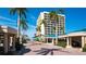 Exterior view showing covered parking and beach access lined with mature palms at 5966 Midnight Pass Rd # G-51 & G-58, Sarasota, FL 34242