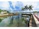 Private dock with boat, offering convenient access to the water and stunning waterfront views for boating enthusiasts at 5966 Midnight Pass Rd # G-51 & G-58, Sarasota, FL 34242
