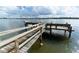 Wooden dock featuring railings and waterfront views with access to the open water at 5966 Midnight Pass Rd # G-51 & G-58, Sarasota, FL 34242