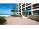 Attractive entrance to the condo building with beautiful landscaping and beach access at 5966 Midnight Pass Rd # G-51 & G-58, Sarasota, FL 34242