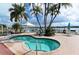 Inviting hot tub with waterfront views and lush landscaping, offering a private oasis for relaxation and enjoyment at 5966 Midnight Pass Rd # G-51 & G-58, Sarasota, FL 34242