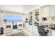 Comfortable living room with built-in shelving, elegant furnishings, and a serene ocean view at 5966 Midnight Pass Rd # G-51 & G-58, Sarasota, FL 34242