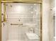 Bright bathroom with glass shower, tiled walls, and gold fixtures at 5966 Midnight Pass Rd # G-51 & G-58, Sarasota, FL 34242